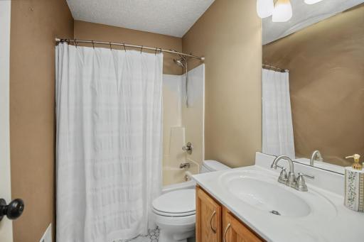 Upper-level full bath conveniently serves the secondary bedrooms.