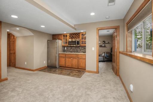 Custom cabinetry, beverage storage and counter space complete the lower-level wet bar.
