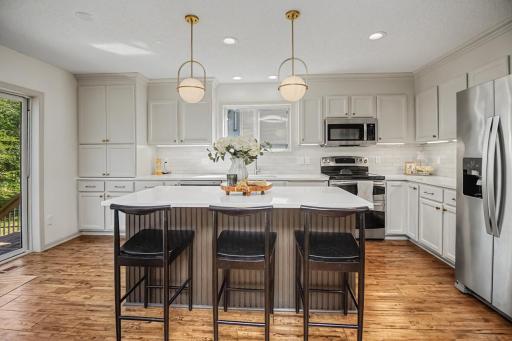 Generous center island offers plenty of prep space plus casual seating.