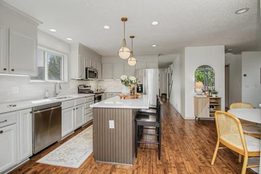 Updated lighting, stainless steel appliances and a crisp neutral palette complete the kitchen.