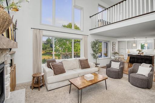 Soaring windows fill the living room with natural light and backyard views.