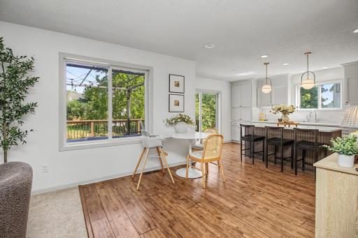 Informal dining area is surrounded by windows with convenient access to the deck.