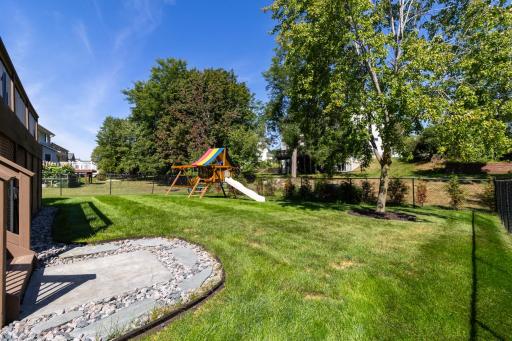 Mature trees and a spacious yard create an inviting setting for enjoying the outdoors.