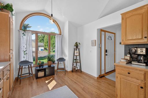Sun-filled kitchen and dining area with beautiful arched windows adding character and natural light.