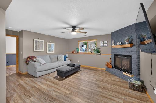 Downstairs, the cozy lower-level family room is anchored by a gas fireplace for added warmth and character.