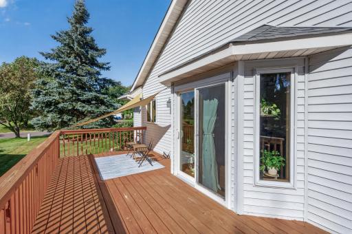 Step outside to the spacious deck overlooking the peaceful, tree-lined backyard.