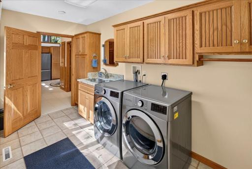 Main-Level Laundry Room with Cabinet Storage and Utility Sink