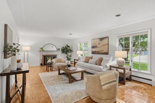 Living room with wood-burning fireplace and big front window