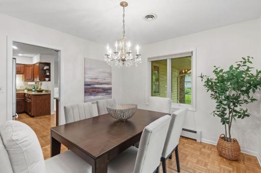 Dining room with chandelier and hardwood floors