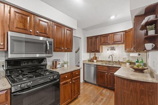 Large kitchen with granite counters and gas range