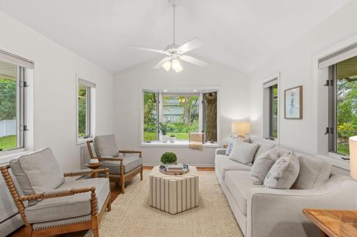 Sunroom addition with vaulted ceiling and bay window