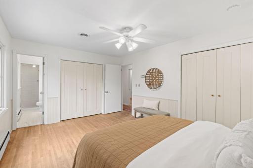 Primary bedroom with double closet and hardwood floors