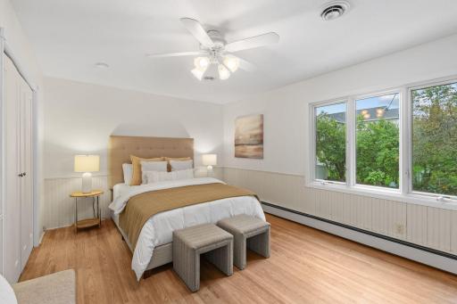Primary bedroom with hardwood floors and ceiling fan