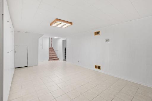 Lower-level family room with wood-burning fireplace
