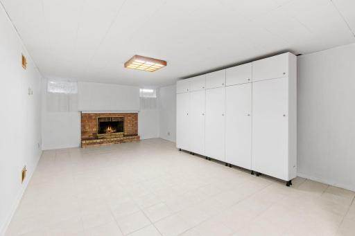 Lower-level family room with wood-burning fireplace