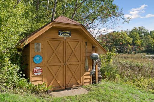 Additional backyard storage shed provides convenient space for lawn equipment, outdoor gear, and seasonal storage.