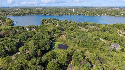 Beautiful aerial view showing the home’s location near Lake Gervais, surrounded by mature trees, parks, trails, and natural scenery.