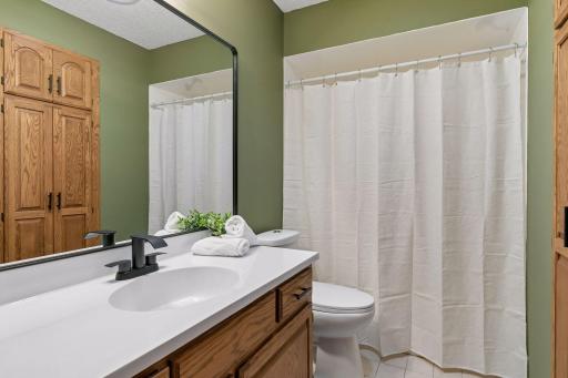 Upper-level full bath with updated vanity, tub/shower and plenty of built-in storage.