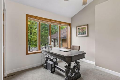 Main-level bedroom currently used as a home office offers valuable flexibility for guests, working from home or multigenerational living.