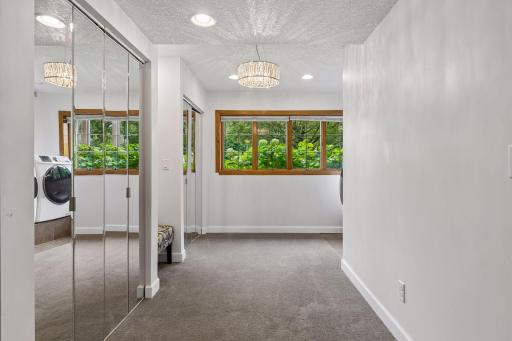 Additional space with large windows and mirrored closets offers flexibility for dressing, storage, a sitting area, or other everyday needs.