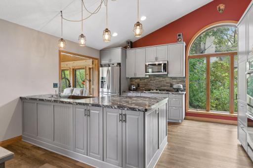 Large center island provides plenty of prep and gathering space, while extensive cabinetry and stainless steel appliances make this kitchen functional for everyday cooking and entertaining.