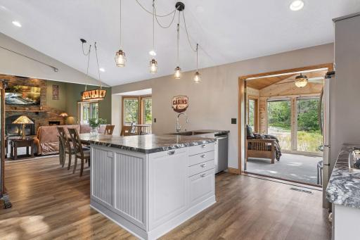 Kitchen opens directly to the 3-season porch, making it easy to enjoy morning coffee, casual meals or relaxing evenings surrounded by pond and wildlife views.
