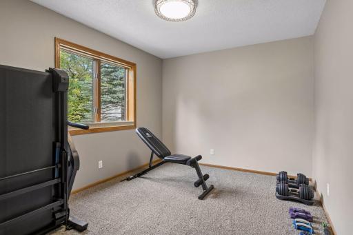 Third upper-level bedroom currently used as a home gym - flexible space for a bedroom, fitness room or home office.