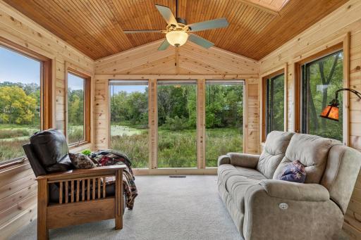 Window-filled 3-season porch with beautiful pond and wildlife views - a perfect place to relax and enjoy nature.