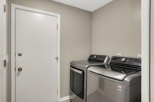 Main floor laundry room located off kitchen.