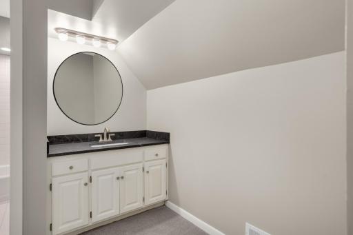 Primary private vanity with huge walk in closest adjacent to it.