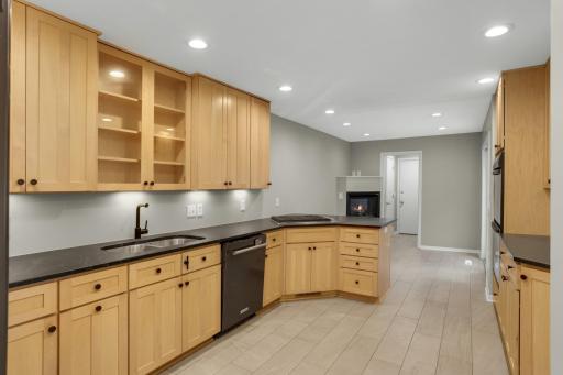Eat in dining area features a gas fireplace with an oversized patio door opening to the front courtyard.