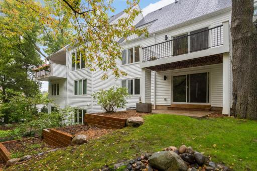 Lower level patio overlooks landscaping and greenery.