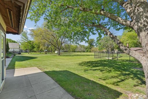 The meticulously landscaped yard is tilled, leveled, and hydro-seeded, with a full irrigation system for the lawn, flower beds, and vegetable garden.