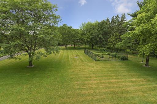 The meticulously landscaped yard is tilled, leveled, and hydro-seeded, with a full irrigation system for the lawn, flower beds, and vegetable garden.