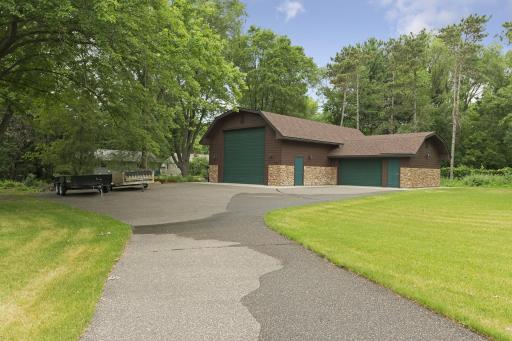A separate 1,440 sq ft detached garage is equally impressive, with heated floors, A/C, insulation, 1/4 bath, floor drain, cable TV, internet, and a security system