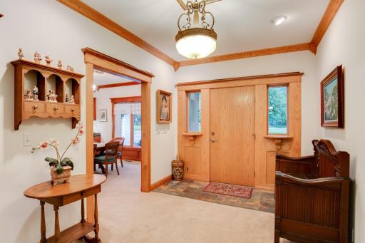 Spacious foyer featuring 11-inch smooth cedar trim, with seamless access to the formal dining room and living room.