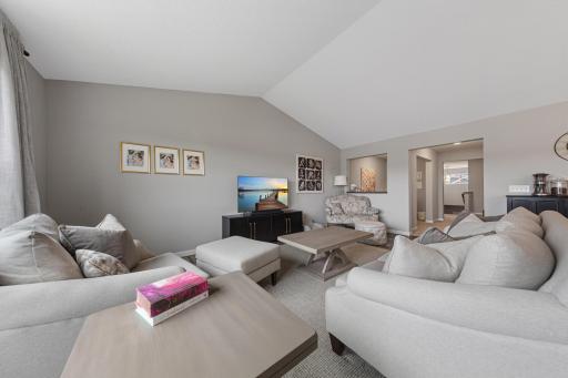 Living room area with tall ceilings and large windows.