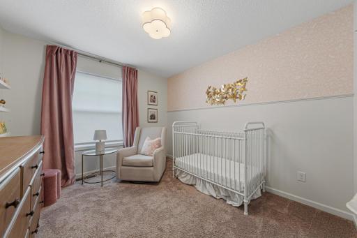 Bedroom three of the upper level. Very cute nursery.
