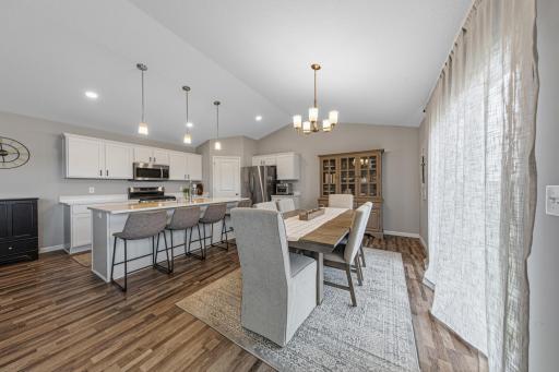 Dining area with LVP flooring, beautiful lighting and elegant decor.