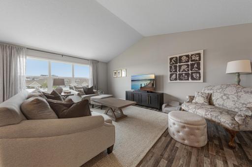 Living room area with tall ceilings and large windows.