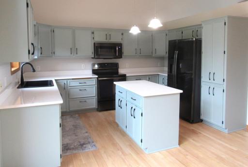Pantry cupboard, center island with GFI, GE Profile refrigerator with water dispenser, GE Profile 5 burner stove, and 12' ceilings!