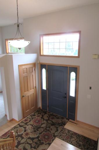 Another view of the entry with matching transom window in the living room. The living room, kitchen, informal dining, both stairways and upper hallway has fresh paint.