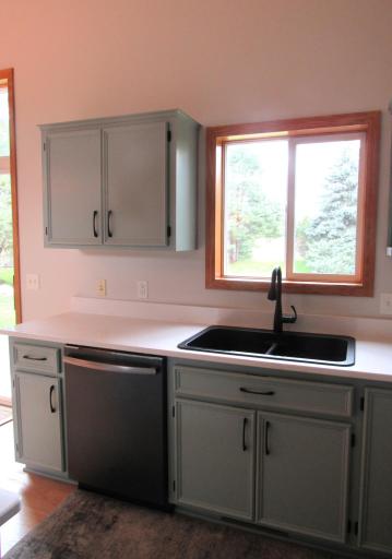 Upscale German composite sink and touchless pull down faucet, GE Profile black stainless steel dishwasher.