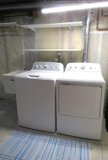 Ceramic tiled floor in the utility room. GE washer and dryer will stay!