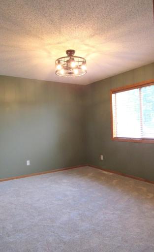 The 13x12 primary bedroom has a step in closet, ceiling light/fan and walks through to the main bath.