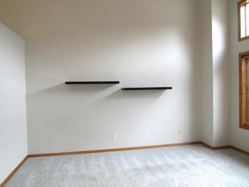 The living room has 12' ceilings, ceiling fan, fresh paint, new carpet, a transom window and very nice blinds. This living room could easily be used as a formal dining room!