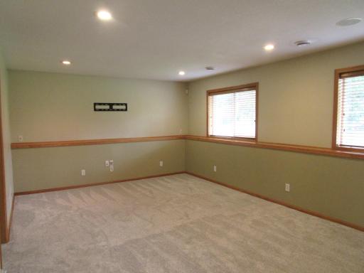 Lower level family room with new carpet, day windows, recessed lighting and tons of space.