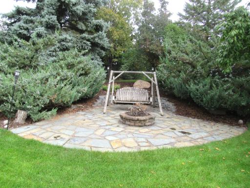 Private paver fire pit area with lighting.