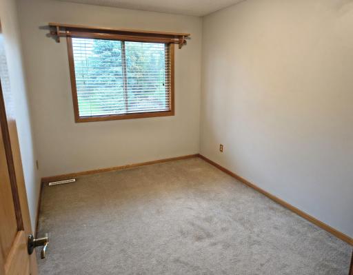 Upper level bedroom #3 with a big double closet, 6 panel doors and nice blinds with a shelf above the window.