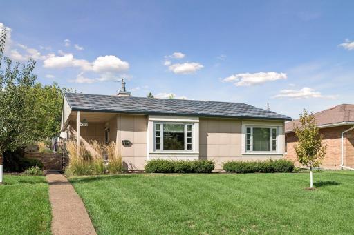 Original exterior detailing preserves the character of this postwar modern home.